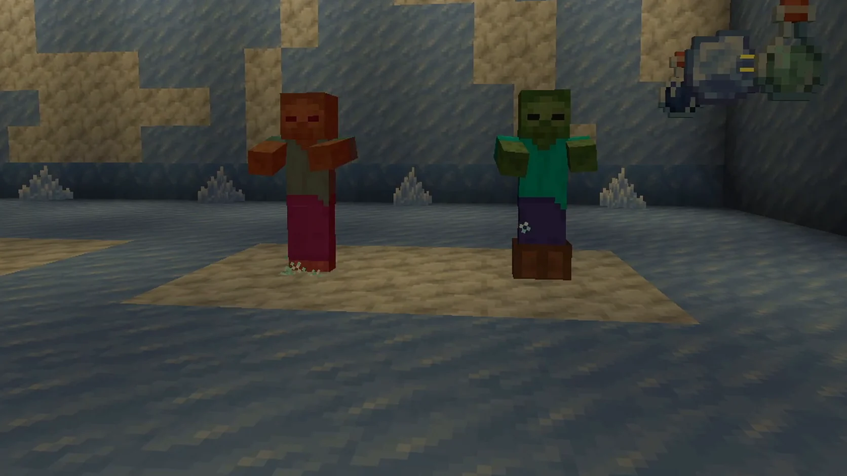 Dos zombis en una sala de hielo: el de la izquierda, sin armadura, se ve rojo por el daño de la Congelación; el de la derecha, con botas de cuero, sigue verde
